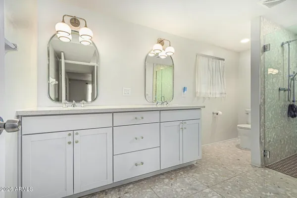 a bathroom with a double vanity sink and a mirror