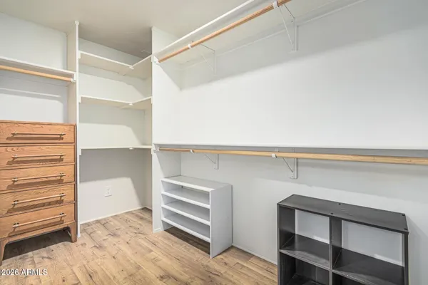 a view of walk in closet with empty racks
