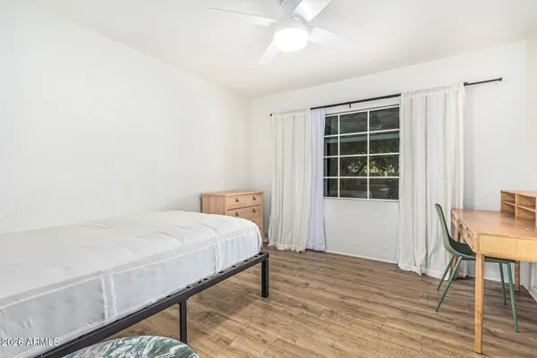 a bedroom with a bed and a table in it