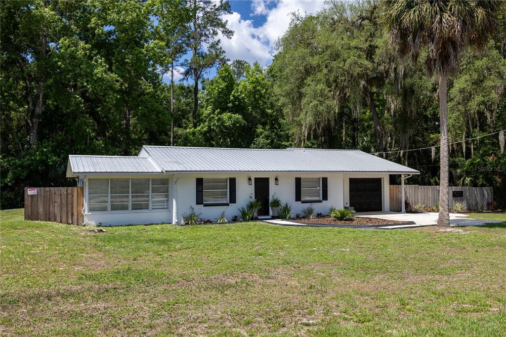 113 Browns Road San Mateo, FL 32187 - Photo 1 of 36 a front view of house with yard and green space