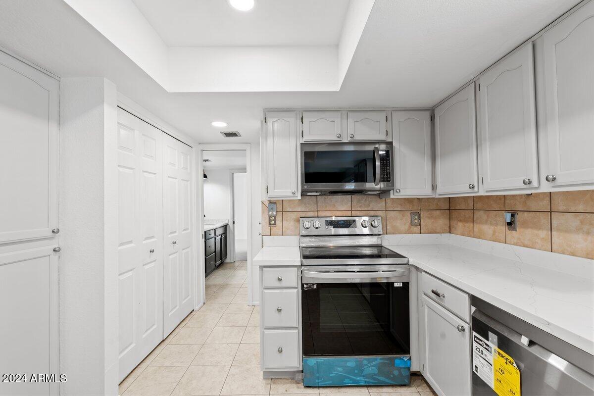 6105 North 12th Way Phoenix, AZ 85014 - Photo 11 of 29 a kitchen with cabinets and steel appliances
