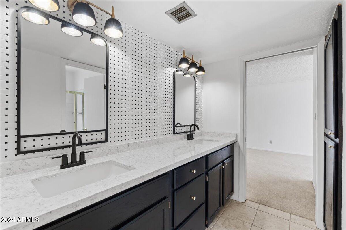 6105 North 12th Way Phoenix, AZ 85014 - Photo 15 of 29 a bathroom with a sink and a mirror