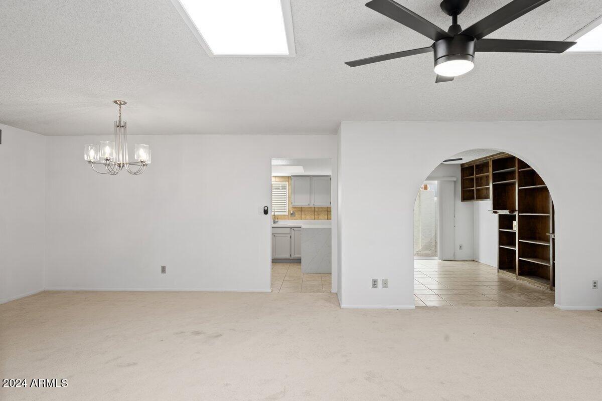 6105 North 12th Way Phoenix, AZ 85014 - Photo 6 of 29 an empty room with windows and ceiling fan