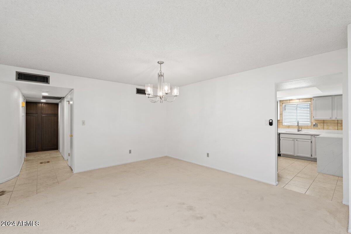 6105 North 12th Way Phoenix, AZ 85014 - Photo 7 of 29 an empty room with a kitchen and a sink