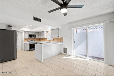 a kitchen with stainless steel appliances a refrigerator sink and microwave