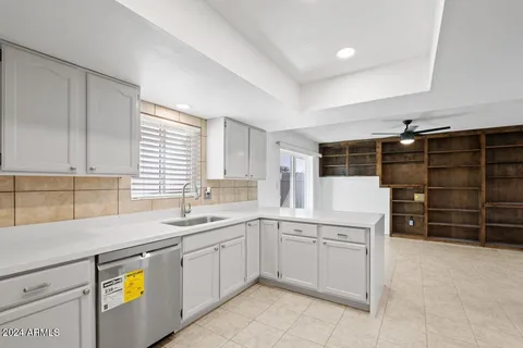 a kitchen with cabinets and steel appliances