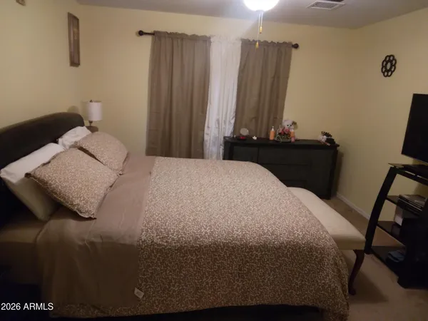 a bedroom with a bed and a mirror