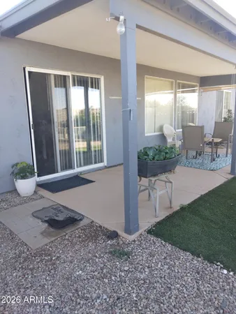 a view of a livingroom with furniture and floor to ceiling window
