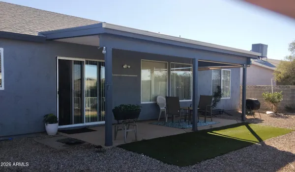 a view of a patio with table and chairs