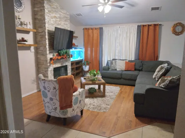 a living room with furniture fireplace and a flat screen tv