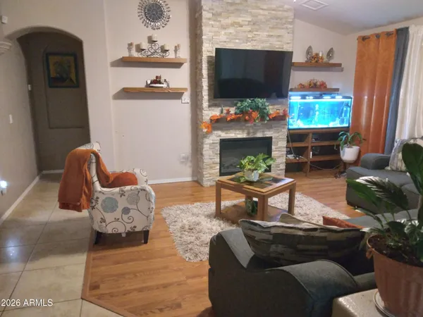 a living room with furniture a flat screen tv and a window
