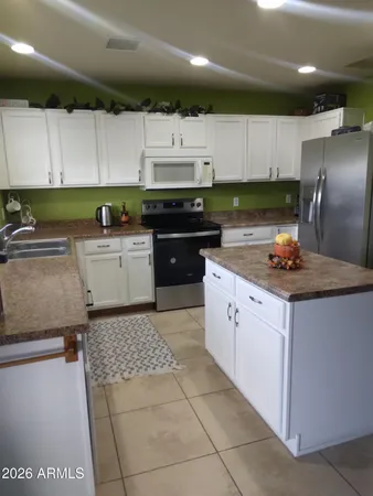 a kitchen with a sink a stove and cabinets