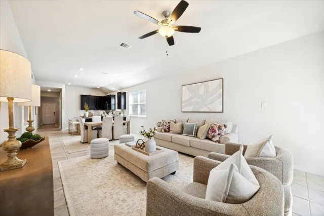 a living room with furniture chandelier and a large mirror