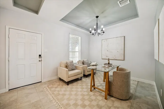 a living room with furniture and a chandelier