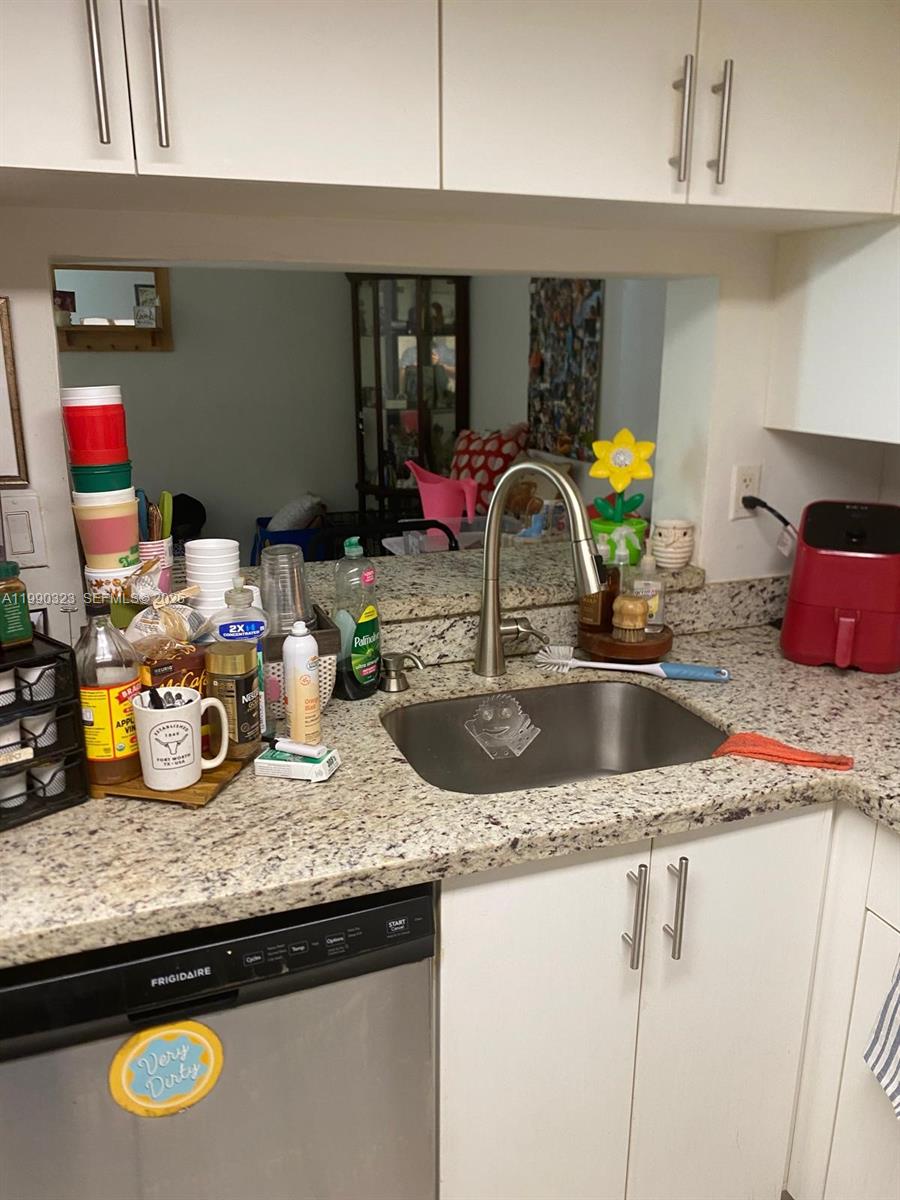 11800 Southwest 18th Street, Unit 1084 Miami, FL 33175 - Photo 13 of 30 a kitchen with sink and a granite counter tops