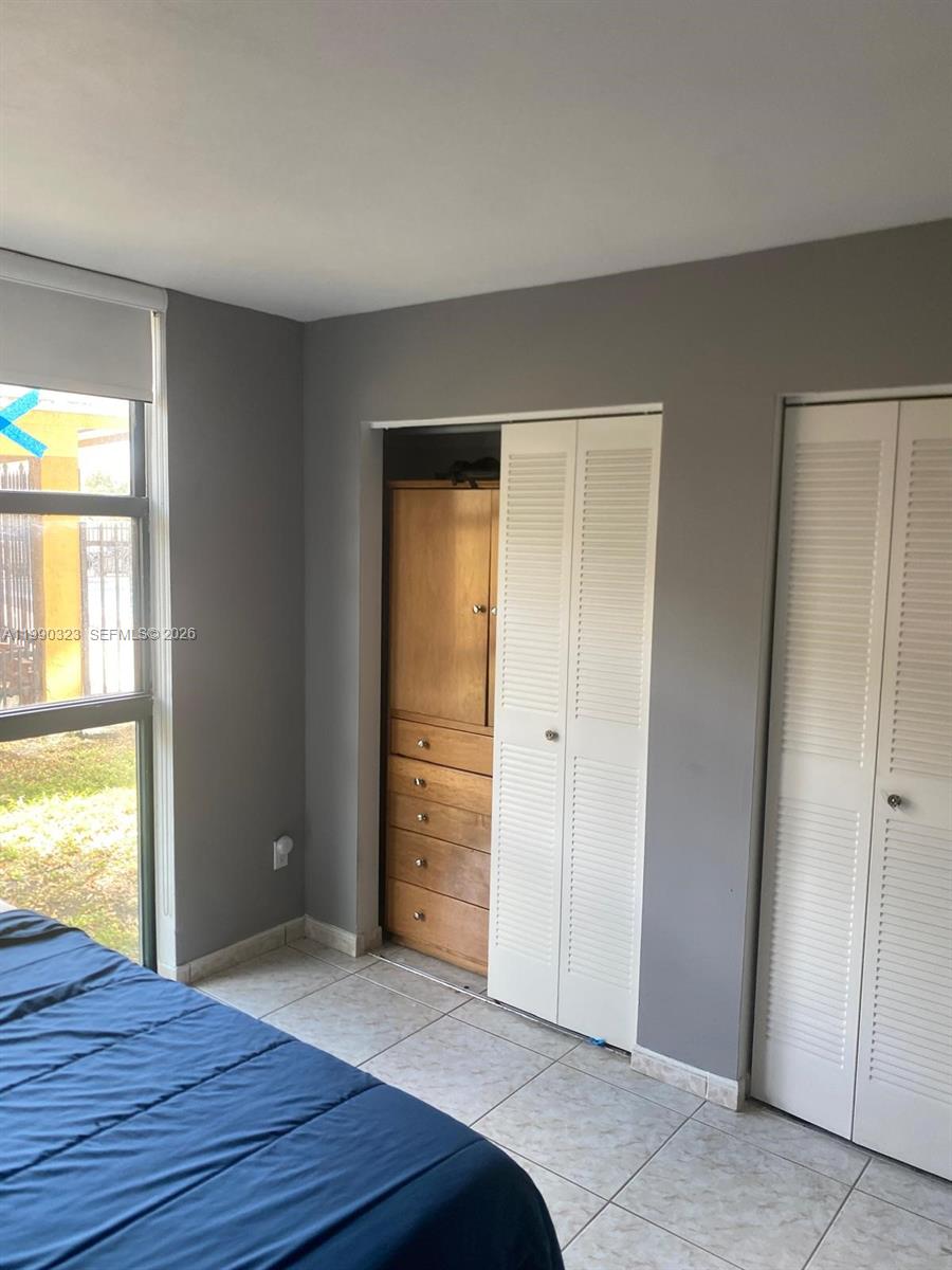 11800 Southwest 18th Street, Unit 1084 Miami, FL 33175 - Photo 18 of 30 a bedroom with a bed and a window