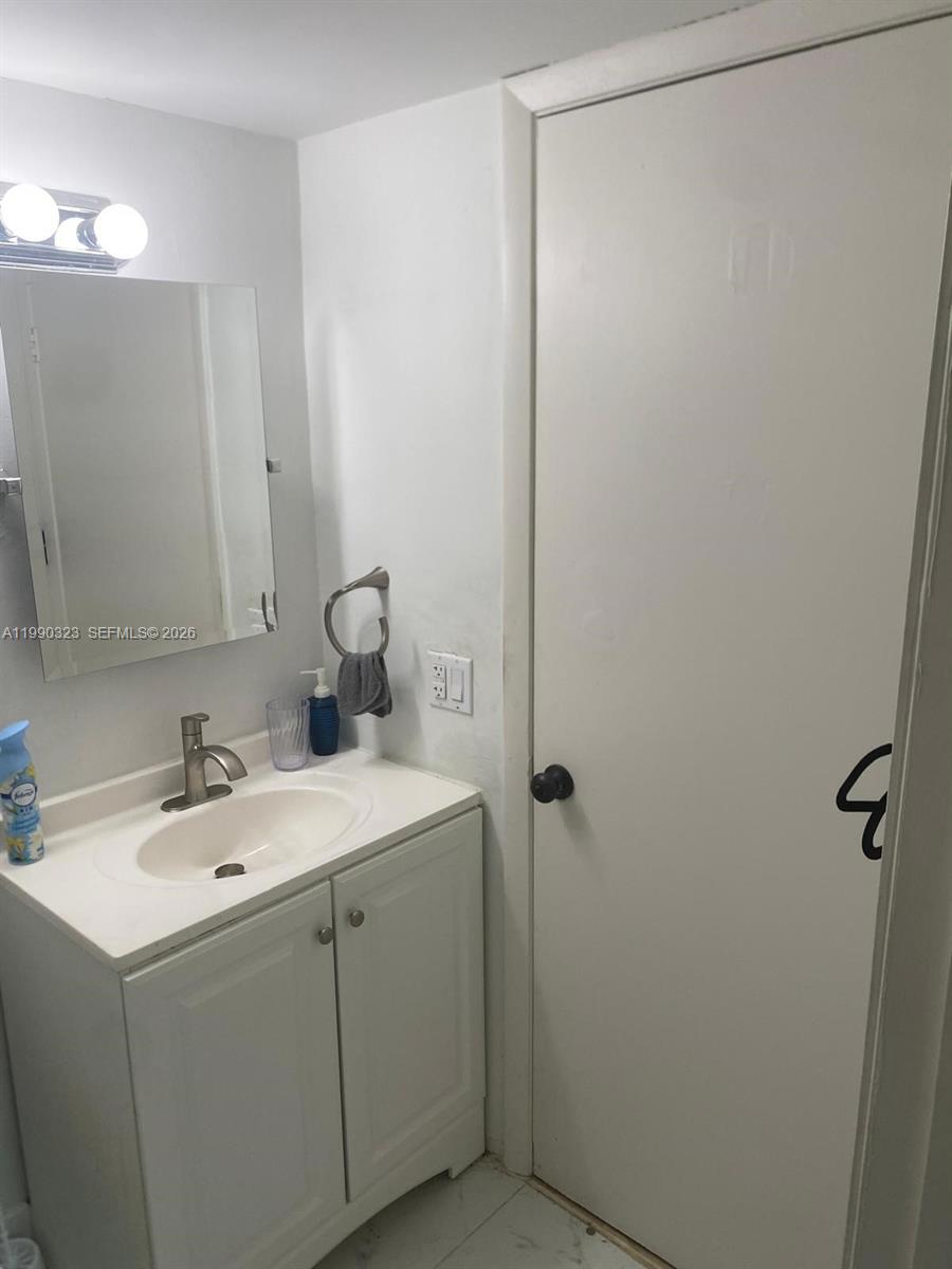 11800 Southwest 18th Street, Unit 1084 Miami, FL 33175 - Photo 20 of 30 a bathroom with a sink and a mirror