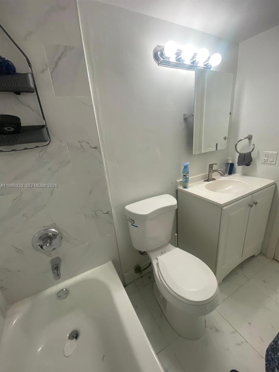 11800 Southwest 18th Street, Unit 1084 Miami, FL 33175 - Photo 22 of 30 a white toilet sitting next to a bath tub