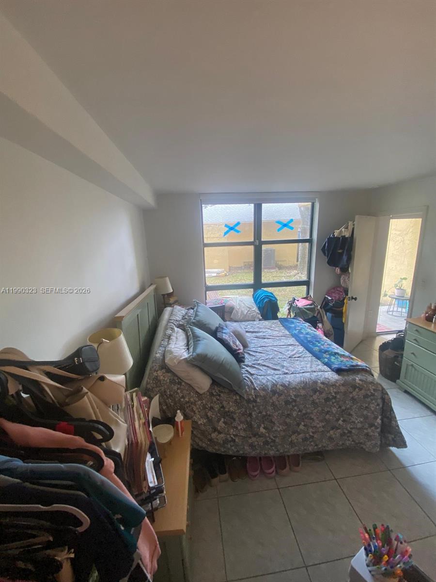 11800 Southwest 18th Street, Unit 1084 Miami, FL 33175 - Photo 23 of 30 a bedroom with a bed and wooden floor