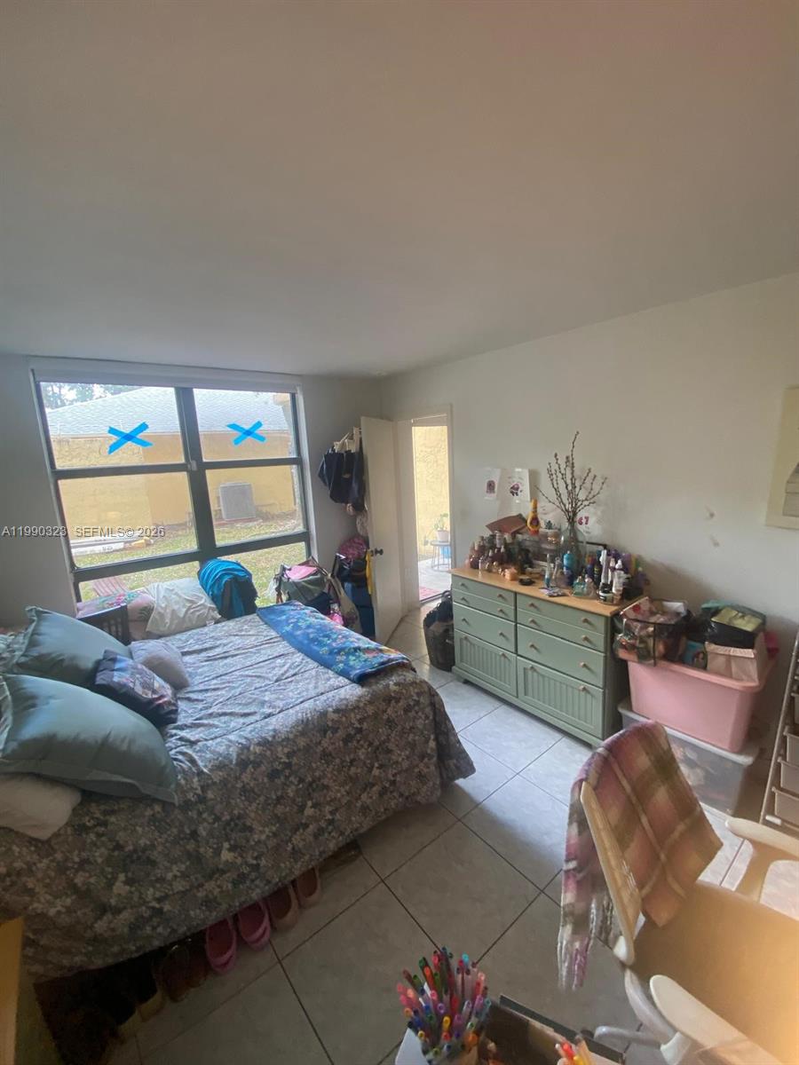 11800 Southwest 18th Street, Unit 1084 Miami, FL 33175 - Photo 24 of 30 a bedroom with a bed and window