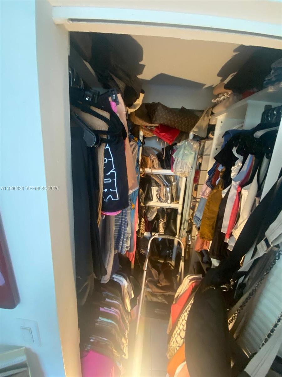 11800 Southwest 18th Street, Unit 1084 Miami, FL 33175 - Photo 25 of 30 a view of walk in closet with clothes and shoes