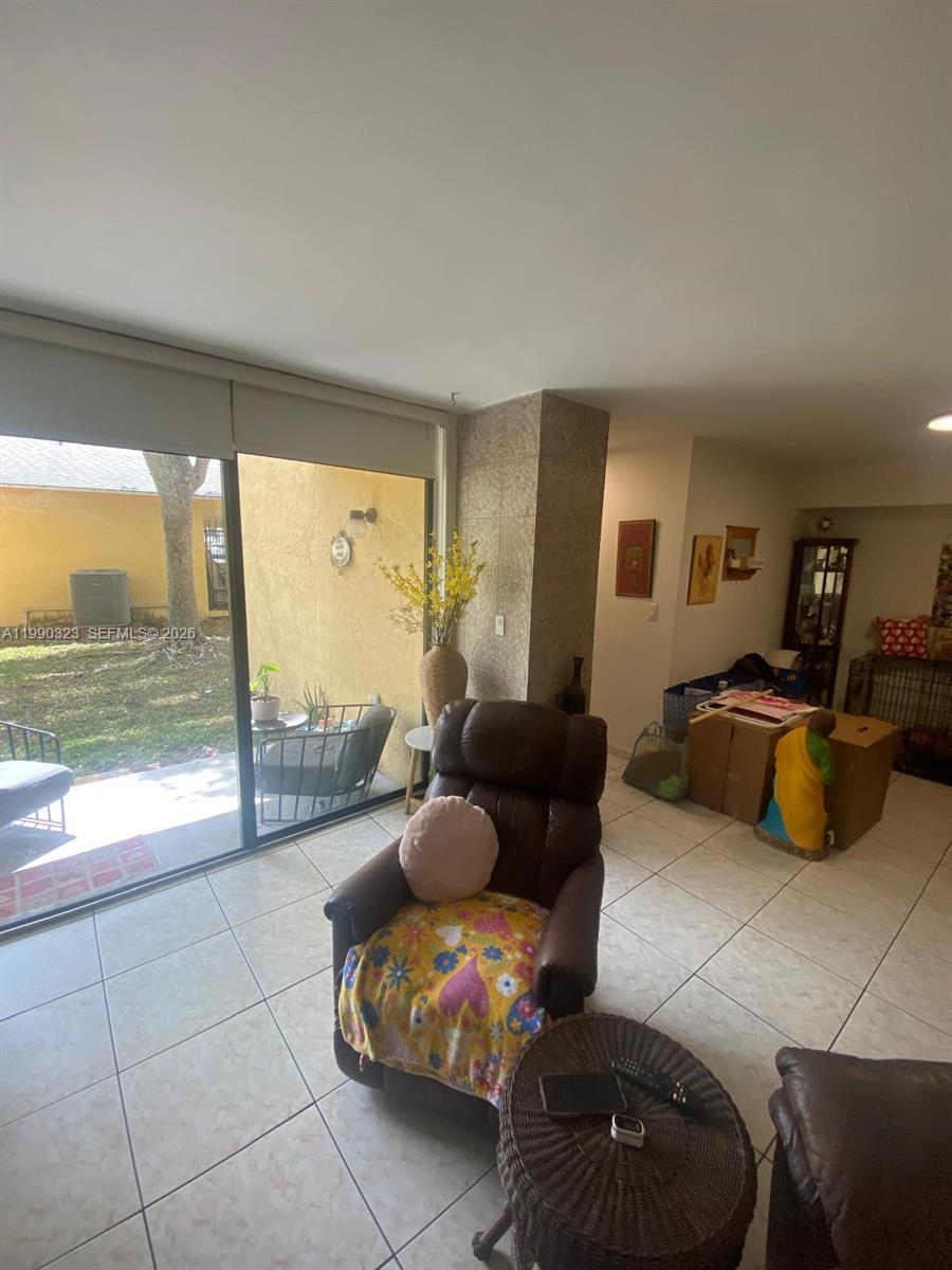 11800 Southwest 18th Street, Unit 1084 Miami, FL 33175 - Photo 10 of 30 a living room with furniture and a large window