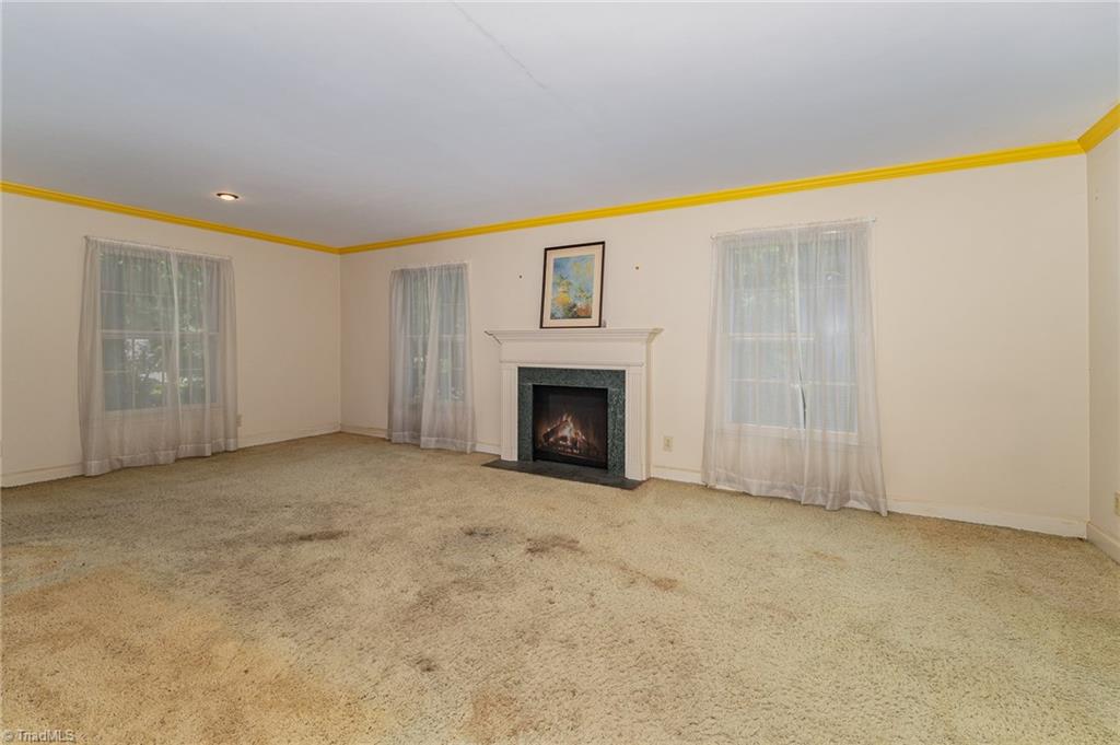 303 Kirk Road Greensboro, NC 27455 - Photo 3 of 26 Living room has hardwood under carpet