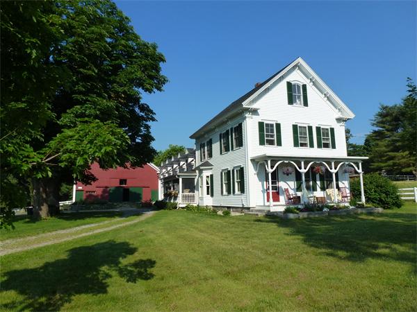 394 Littlefield Road Boxborough, MA 01719 - Photo 1 of 21 a front view of a house with a garden and trees