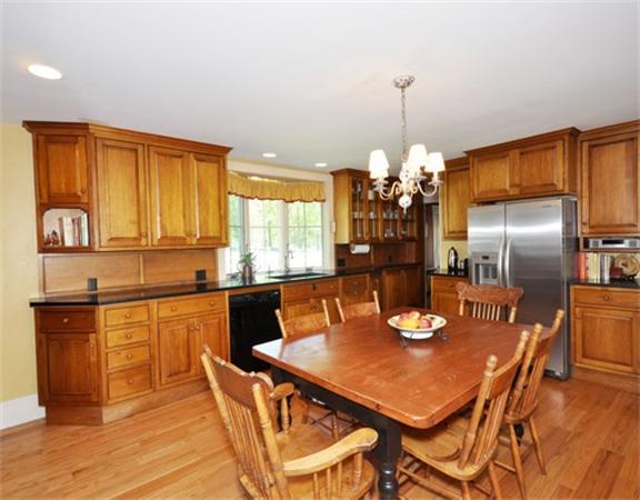 394 Littlefield Road Boxborough, MA 01719 - Photo 9 of 21 a kitchen with a dining table chairs and refrigerator