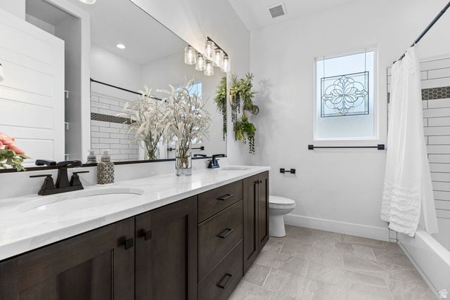 3022 West Sesia Way St. George, UT 84770 - Photo 30 of 52 Bathroom with double vanity, shower / tub combo, and light stone finish floors