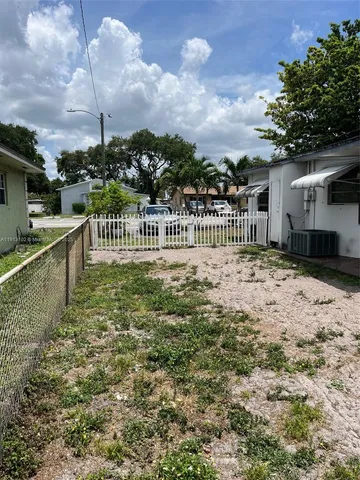 a view of a house with a wooden fence