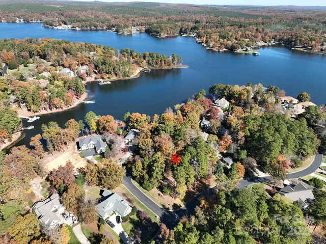 an aerial view of lake and residential houses with outdoor space