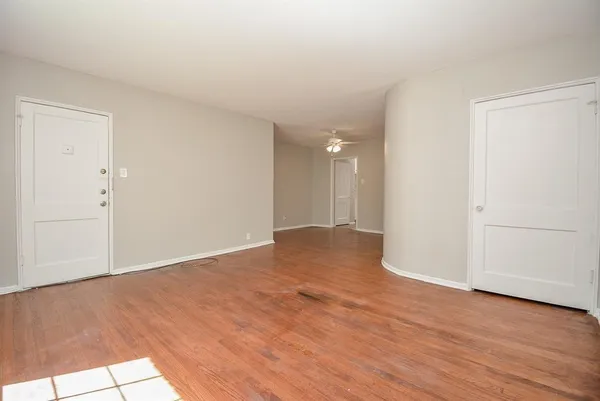 a view of an empty room and wooden floor