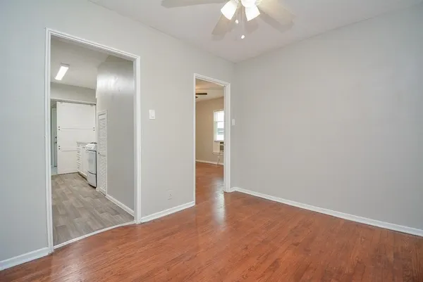 a view of a hallway with wooden floor