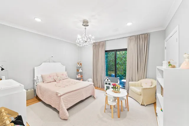 a bedroom with a bed and a chandelier