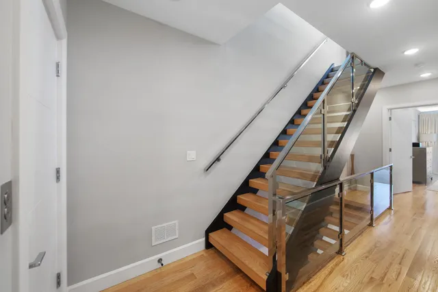 a view of entryway and hall with wooden floor