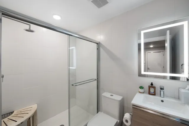a bathroom with a sink toilet and shower