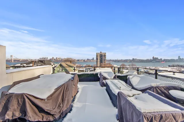 a terrace with outdoor seating and city view
