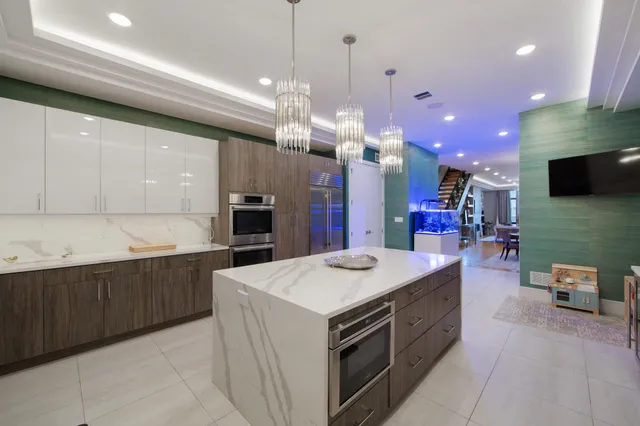 a large kitchen with a counter space a sink and appliances