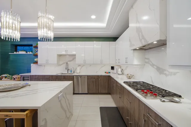 a kitchen with a sink a stove and cabinets