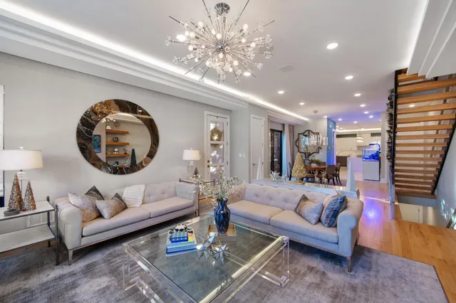 a living room with furniture and a chandelier