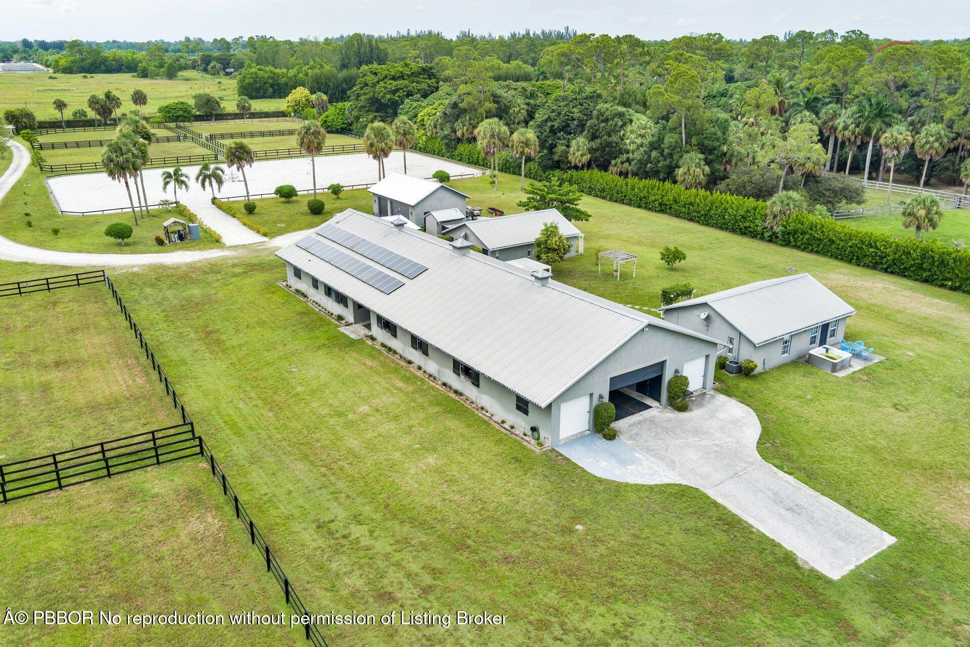 2770 E Road Loxahatchee, FL 33470 - Photo 50 of 51 a view of a house with pool and a yard