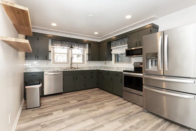 a kitchen with granite countertop a sink and a stove