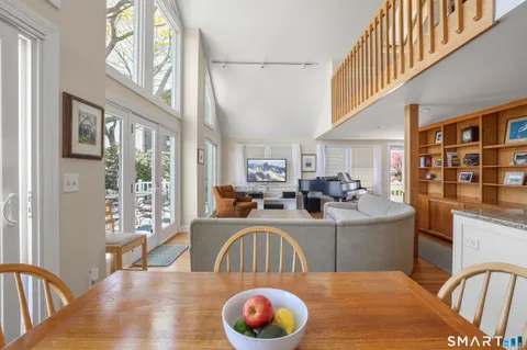 a living room with furniture a fireplace and a large window