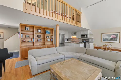 a living room with furniture and a painting on the wall