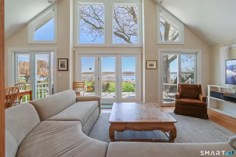 a living room with furniture large window and a large window