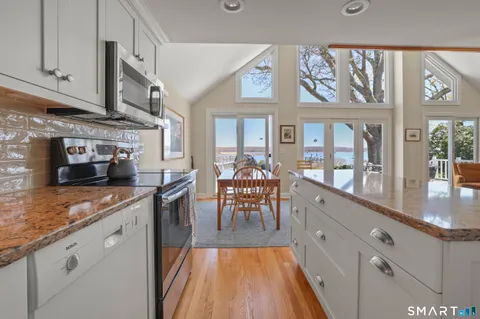 a kitchen with stainless steel appliances granite countertop a stove and cabinets