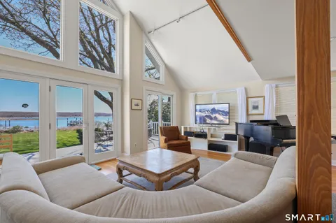 a living room with furniture and a floor to ceiling window