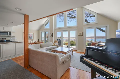 a living room with furniture and a piano