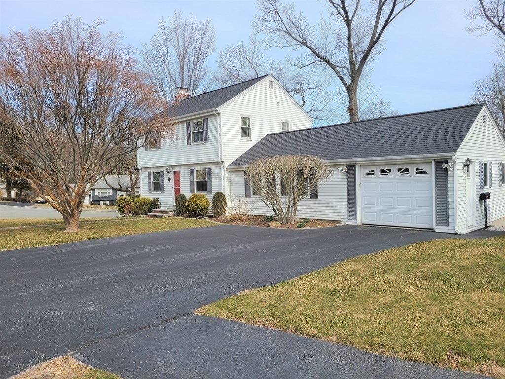 1 Lexington Circle Canton, MA 02021 - Photo 3 of 41 a front view of a house with a yard and garage